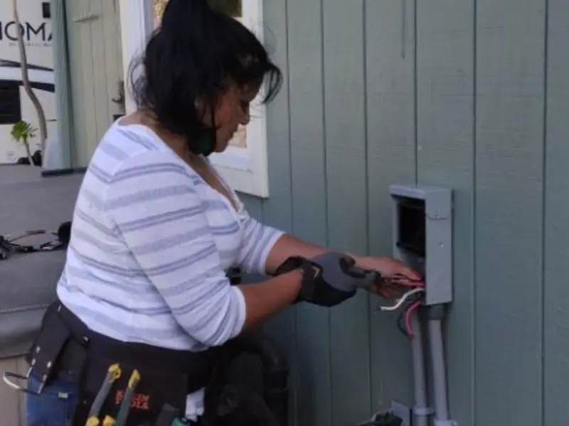 Licensed electrician wiring an exterior subpanel in Tabor City